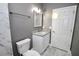 Bathroom featuring marble tile, grey walls, granite countertop, and a door to another room at 1508 W 16Th St, Sanford, FL 32771