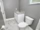 Bathroom featuring marble tile floors, white vanity, and a toilet at 1508 W 16Th St, Sanford, FL 32771