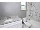 Bathroom showcasing a marble tile shower, granite sink, and white cabinets at 1508 W 16Th St, Sanford, FL 32771