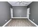 Empty bedroom with gray walls, white doors and trim, and wood flooring at 1508 W 16Th St, Sanford, FL 32771