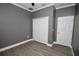 Bedroom featuring grey walls, wood-look flooring, white trim, and a closet with double doors at 1508 W 16Th St, Sanford, FL 32771