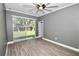 Bright bedroom featuring sliding glass doors to the backyard and wood-look flooring at 1508 W 16Th St, Sanford, FL 32771