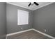 Cozy bedroom featuring a ceiling fan and a window bringing in natural light at 1508 W 16Th St, Sanford, FL 32771