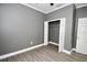 Simple bedroom with wood-look floors and a closet with folding doors at 1508 W 16Th St, Sanford, FL 32771