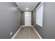 Bright entryway featuring wood-look floors, grey walls and a white front door with a window at 1508 W 16Th St, Sanford, FL 32771