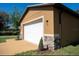 Home's exterior with a two-car garage, stone accents, fresh paint, new driveway and manicured landscaping at 1508 W 16Th St, Sanford, FL 32771