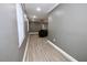 Hallway with new, light colored, wood-look flooring, light gray walls, white trim and baseboards and recessed lighting at 1508 W 16Th St, Sanford, FL 32771