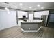 Contemporary kitchen features white cabinets, granite countertops, and an island at 1508 W 16Th St, Sanford, FL 32771