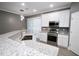 Spacious kitchen with stainless steel appliances, granite counters, white cabinets, and modern fixtures at 1508 W 16Th St, Sanford, FL 32771