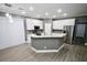 Modern kitchen with white cabinetry, granite countertops, stainless steel appliances, and an island at 1508 W 16Th St, Sanford, FL 32771