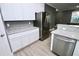 Modern kitchen boasts white cabinets, granite countertops, and stainless steel appliances at 1508 W 16Th St, Sanford, FL 32771