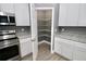 Pantry in this kitchen features stainless steel appliances, granite counters, white cabinets and gray walls at 1508 W 16Th St, Sanford, FL 32771