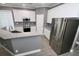 Spacious kitchen with stainless steel appliances, granite counters, white cabinets, an island and gray walls at 1508 W 16Th St, Sanford, FL 32771