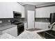 Well-lit kitchen with stainless steel appliances, granite counters, white cabinets, and modern fixtures at 1508 W 16Th St, Sanford, FL 32771