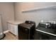 Well-equipped laundry room with modern washer and dryer and storage cabinets at 1508 W 16Th St, Sanford, FL 32771