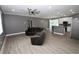 View of living room with open concept, fan, wood floors, and kitchen at 1508 W 16Th St, Sanford, FL 32771