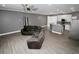 Spacious living room and kitchen area featuring stainless steel appliances, grey walls, and wood-look flooring at 1508 W 16Th St, Sanford, FL 32771
