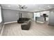 Open-concept living room with stainless steel appliances, grey walls, wood-look flooring, and natural light at 1508 W 16Th St, Sanford, FL 32771