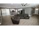 Open-concept living room with a large comfortable couch and sleek flooring at 1508 W 16Th St, Sanford, FL 32771