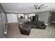 Open-concept living room with modern gray walls, wood floors, and an oversized leather sofa at 1508 W 16Th St, Sanford, FL 32771