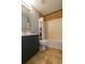Cozy bathroom with tiled walls, vanity with mirror and a shower with tub at 15733 Switch Cane St, Clermont, FL 34711
