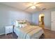 Bedroom with neutral decor and an archway leading to the ensuite bathroom at 15733 Switch Cane St, Clermont, FL 34711