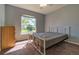 Bright bedroom with a large window overlooking the backyard and neutral carpet at 15733 Switch Cane St, Clermont, FL 34711