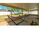 A hammock invites relaxation on a shaded screened-in back patio at 15733 Switch Cane St, Clermont, FL 34711