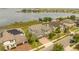 Aerial view of a stunning house with solar panels situated on the water with a dock and a long driveway at 16689 Broadwater Ave, Winter Garden, FL 34787