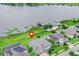 Aerial view of the property showcasing lakefront location with dock, lush greenery, and proximity to the water at 16689 Broadwater Ave, Winter Garden, FL 34787