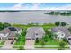 Stunning lakefront home featuring lush landscaping, a paver driveway, and a serene waterfront view at 16689 Broadwater Ave, Winter Garden, FL 34787