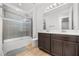 Bathroom featuring dark cabinets and modern shower with tile surround at 16689 Broadwater Ave, Winter Garden, FL 34787