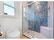 Bathroom featuring modern shower with blue scalloped tile design at 16689 Broadwater Ave, Winter Garden, FL 34787