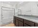 Bathroom featuring gray granite countertop and tiled tub and shower at 16689 Broadwater Ave, Winter Garden, FL 34787