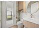 Bright bathroom with modern vanity, toilet, wood accents, and access to an outdoor patio space at 16689 Broadwater Ave, Winter Garden, FL 34787