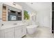 Luxurious bathroom featuring dual vanities, a soaking tub, and modern fixtures at 16689 Broadwater Ave, Winter Garden, FL 34787