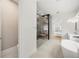 Bright bathroom featuring a soaking tub, walk-in shower, and adjacent bedroom area at 16689 Broadwater Ave, Winter Garden, FL 34787