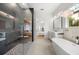 Spacious bathroom with walk-in shower, soaking tub, and modern fixtures offers luxury and relaxation at 16689 Broadwater Ave, Winter Garden, FL 34787