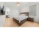 Cozy bedroom with hardwood floors, a large bed, and stylish window shades at 16689 Broadwater Ave, Winter Garden, FL 34787