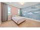 Bedroom boasting mural feature wall and bright light from windows at 16689 Broadwater Ave, Winter Garden, FL 34787