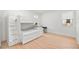 Bedroom showcasing a bunk bed, wood floor, white wall, and black desk near a window at 16689 Broadwater Ave, Winter Garden, FL 34787
