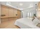 Light-filled bedroom with modern style wood accent wall and scenic lake view at 16689 Broadwater Ave, Winter Garden, FL 34787