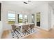 Sunlit dining area with modern decor features large windows overlooking water views at 16689 Broadwater Ave, Winter Garden, FL 34787