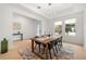 Bright dining room boasts tray ceiling, modern chandelier, and large windows, creating an inviting atmosphere at 16689 Broadwater Ave, Winter Garden, FL 34787