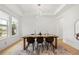 Bright dining room boasts tray ceiling, modern chandelier, and large windows, creating an inviting atmosphere at 16689 Broadwater Ave, Winter Garden, FL 34787