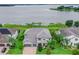 Aerial view of a two-story home with a gray tile roof on a lake at 16689 Broadwater Ave, Winter Garden, FL 34787