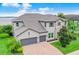 Beautiful two-story home boasts a three-car garage, stone accents, and well-manicured lawn at 16689 Broadwater Ave, Winter Garden, FL 34787