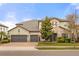 Beautiful two-story home featuring stone and stucco accents, a tile roof, and a three-car garage at 16689 Broadwater Ave, Winter Garden, FL 34787