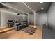Modern home theater with comfortable seating, a large screen, dimmable lighting, and wood-look floors at 16689 Broadwater Ave, Winter Garden, FL 34787