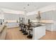 Modern kitchen with sleek white cabinets, black countertops, an island, and stainless steel appliances at 16689 Broadwater Ave, Winter Garden, FL 34787